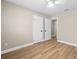 A bedroom with light walls, new flooring, a ceiling fan, and a view to an adjoining hallway at 2066 62Nd Pl S 62Nd Pl, St Petersburg, FL 33712