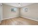 Bright bedroom with light wood floors and two windows providing plenty of natural light at 2066 62Nd Pl S 62Nd Pl, St Petersburg, FL 33712