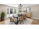 Bright dining room with modern light fixture and sideboard, decorative rug, and glass patio doors at 2066 62Nd Pl S 62Nd Pl, St Petersburg, FL 33712