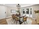 Bright dining room with modern light fixture, decorative rug, and glass patio doors at 2066 62Nd Pl S 62Nd Pl, St Petersburg, FL 33712