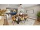 Bright dining room with modern light fixture, decorative rug, open access to other rooms at 2066 62Nd Pl S 62Nd Pl, St Petersburg, FL 33712