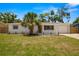 Charming single-story home with a well-manicured lawn, a palm tree, and a one car garage at 2066 62Nd Pl S 62Nd Pl, St Petersburg, FL 33712