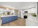 Spacious kitchen with blue cabinets, stainless steel appliances, and open access to the dining area at 2066 62Nd Pl S 62Nd Pl, St Petersburg, FL 33712