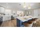 Modern kitchen featuring white cabinets, granite countertops, a blue island, and modern pendant lighting at 2066 62Nd Pl S 62Nd Pl, St Petersburg, FL 33712
