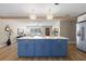 Bright and open living room with kitchen island, modern lighting, neutral colors, and stainless refrigerator at 2066 62Nd Pl S 62Nd Pl, St Petersburg, FL 33712