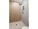 Modern shower with decorative tiling, glass door, and convenient built-in shelf at 2066 62Nd Pl S 62Nd Pl, St Petersburg, FL 33712