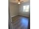Bright bedroom with wood-look floors and window, offering a comfortable living space at 2160 Corbin Pl # C, Palm Harbor, FL 34683