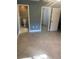 Comfortable main bedroom showcasing tiled floors, adjacent bathroom, and walk-in closet at 2160 Corbin Pl # C, Palm Harbor, FL 34683