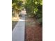 Sidewalk leading to property, bordered by mulch and lush landscaping at 2160 Corbin Pl # C, Palm Harbor, FL 34683