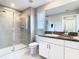 Bathroom with a glass shower door, double sinks and granite counter at 2190 Great Sapphire Ln, Lutz, FL 33558