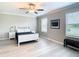 Bright and airy primary bedroom with two windows and hardwood floors at 2190 Great Sapphire Ln, Lutz, FL 33558
