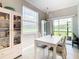 Bright dining area features stylish chandelier and sliding glass door access at 2190 Great Sapphire Ln, Lutz, FL 33558