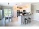 Well-lit kitchen featuring white cabinetry, stainless appliances and breakfast bar at 2190 Great Sapphire Ln, Lutz, FL 33558