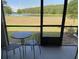 Screened lanai with outdoor seating and a peaceful lake view at 2190 Great Sapphire Ln, Lutz, FL 33558