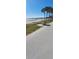 Picturesque beach scene with a waterfront walking path and benches to take in the scenic views at 2469 Trade Winds Dr, Dunedin, FL 34698