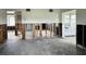 Renovation-ready open-concept living area with original flooring, and studs awaiting reconstruction and design at 2469 Trade Winds Dr, Dunedin, FL 34698