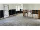 Empty living room with exposed studs and no flooring, ready for a complete renovation at 2469 Trade Winds Dr, Dunedin, FL 34698