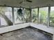 Enclosed sunroom with louvered glass windows, offering plenty of natural light and outdoor views at 2469 Trade Winds Dr, Dunedin, FL 34698