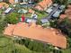 Aerial view of the community highlighting the red tile roofs and manicured landscaping, with a location pointer at 2640 Enterprise E Rd # B25, Clearwater, FL 33759