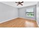 Bedroom featuring a neutral color scheme, hardwood floors, ceiling fan, and a window providing natural light at 2640 Enterprise E Rd # B25, Clearwater, FL 33759