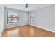 A bedroom with wood floors, a ceiling fan, two windows, and large closet at 2640 Enterprise E Rd # B25, Clearwater, FL 33759
