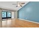 Bedroom featuring a large window, a ceiling fan, and beautiful wood-look floors at 2640 Enterprise E Rd # B25, Clearwater, FL 33759