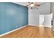 Bedroom featuring a ceiling fan, neutral-colored walls, and wood-look floors at 2640 Enterprise E Rd # B25, Clearwater, FL 33759