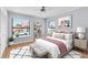 A bedroom featuring a large window, wood floors, decor, and a sitting bench at 2640 Enterprise E Rd # B25, Clearwater, FL 33759