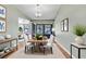 Bright dining room featuring a wooden table with white chairs and modern decor at 2640 Enterprise E Rd # B25, Clearwater, FL 33759