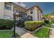 Inviting condo exterior with well-manicured landscaping and charming architectural details at 2640 Enterprise E Rd # B25, Clearwater, FL 33759