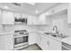 Kitchen featuring white cabinets, subway tile backsplash, and stainless steel appliances at 2640 Enterprise E Rd # B25, Clearwater, FL 33759