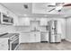 Modern kitchen with white cabinets, stainless steel appliances, and tiled flooring at 2640 Enterprise E Rd # B25, Clearwater, FL 33759