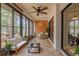 Bright sunroom with large windows, ceiling fan, and casual seating area at 2640 Enterprise E Rd # B25, Clearwater, FL 33759
