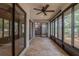 Bright sunroom with large windows, tile floors, and adjacent kitchen at 2640 Enterprise E Rd # B25, Clearwater, FL 33759
