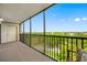 Screened balcony with seating area and scenic outdoor view at 2900 Cove Cay Dr # 7C, Clearwater, FL 33760
