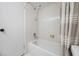 This is a well-lit tub/shower featuring tiled walls and a shower head, blending style with practical functionality at 2900 Cove Cay Dr # 7C, Clearwater, FL 33760