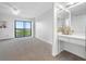 Bedroom with sliding glass doors to balcony and a built-in vanity at 2900 Cove Cay Dr # 7C, Clearwater, FL 33760