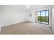 Bedroom features a sliding glass door with natural light and carpet flooring at 2900 Cove Cay Dr # 7C, Clearwater, FL 33760