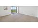 Neutral bedroom with sliding glass doors with carpet flooring at 2900 Cove Cay Dr # 7C, Clearwater, FL 33760