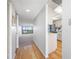 Hallway with wood floors leading to the kitchen and living area with scenic views at 2900 Cove Cay Dr # 7C, Clearwater, FL 33760