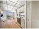 Functional kitchen with white appliances and cabinets, along with a light-filled eating area at 2900 Cove Cay Dr # 7C, Clearwater, FL 33760