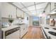 Clean kitchen featuring white cabinets, updated appliances, and hardwood floors at 2900 Cove Cay Dr # 7C, Clearwater, FL 33760