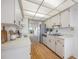 Well-maintained kitchen featuring white cabinetry, modern appliances, and wood flooring at 2900 Cove Cay Dr # 7C, Clearwater, FL 33760