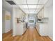 Efficient kitchen with white cabinets, updated appliances, and pass-through to living area at 2900 Cove Cay Dr # 7C, Clearwater, FL 33760