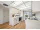 Neat kitchen with white cabinets and updated appliances, and pass-through to living area at 2900 Cove Cay Dr # 7C, Clearwater, FL 33760