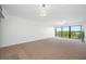 Spacious living room with neutral walls, carpet, and lots of natural light at 2900 Cove Cay Dr # 7C, Clearwater, FL 33760