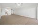 This living room offers carpet, a ceiling fan, and natural light at 2900 Cove Cay Dr # 7C, Clearwater, FL 33760