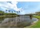 Scenic pond surrounded by palm trees and lush green landscape at 2900 Cove Cay Dr # 7C, Clearwater, FL 33760
