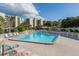 Outdoor pool with lounge chairs surrounded by lush landscaping at 2900 Cove Cay Dr # 7C, Clearwater, FL 33760