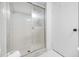 Enclosed shower with a sliding glass door and tiled walls showcasing a clean and functional design at 2900 Cove Cay Dr # 7C, Clearwater, FL 33760